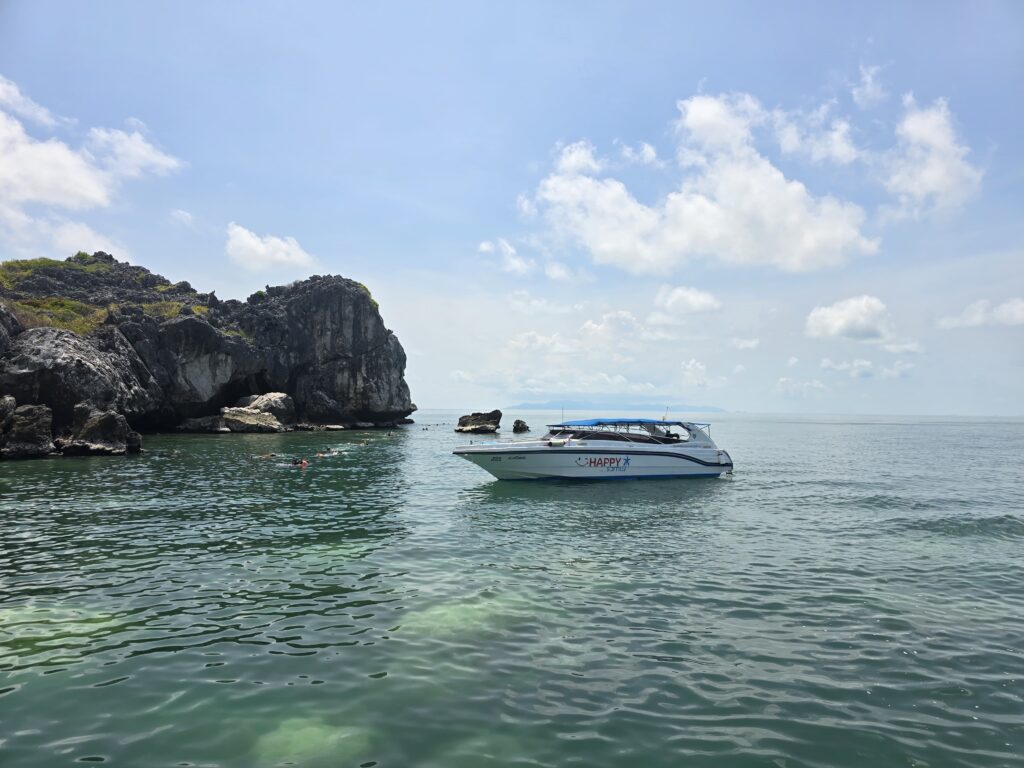 Koh Tao day trip is best for doing snorkeling, as you can see in the picture people are snorkeling in the crystal clear waters.