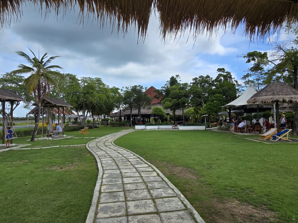 families and children are enjoying and waiting for their flights at Samui airport, Cafes can be seen in right side of the picture.