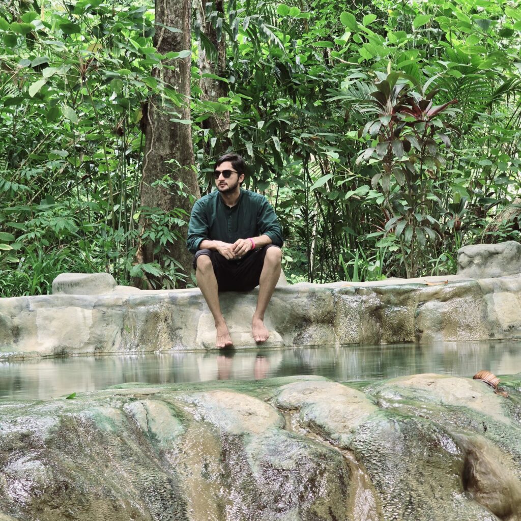 relaxing at the edge of pool by soaking feet in the hot steam water pool