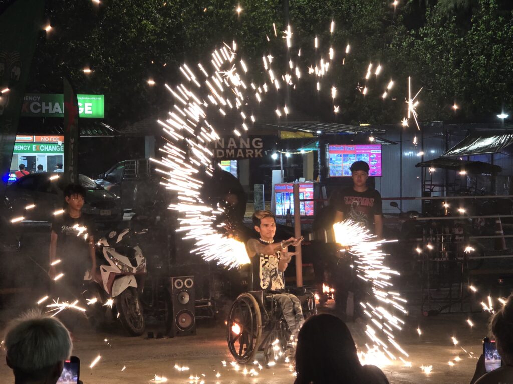 a disabled but talented person is showing his skills on the streets of Ao Nang.